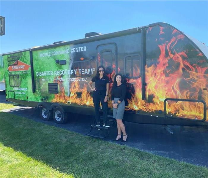 SERVPRO employees in front of 28 ft mobile command center 