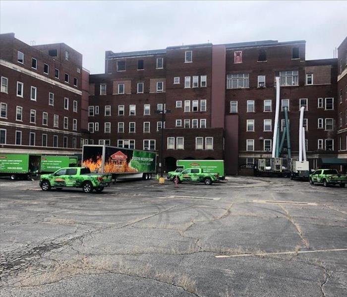 SERVPRO vehicles and equipment in parking lot of job site